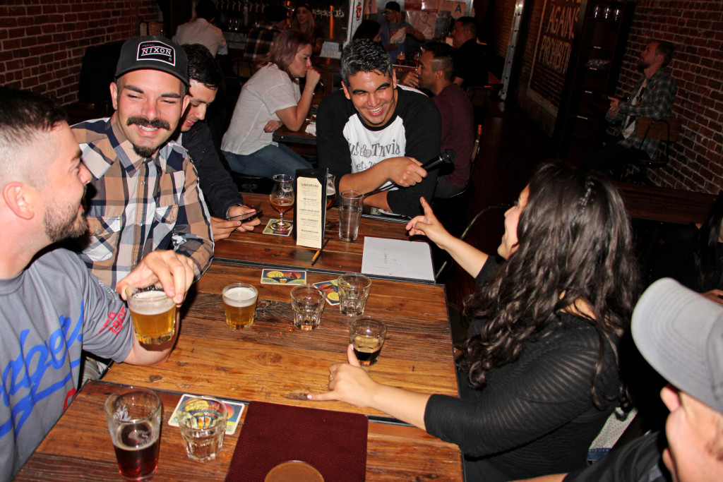 Just Trivia! host Justin Mora (center) gathered with friends at Bread & Barley in Covina. (Photo: Evan Solano / Logos)