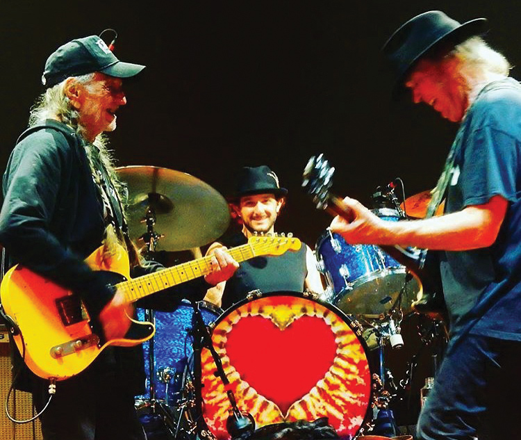Drummer and Citrus alum Anthony LoGerfo drums alongside legendary country artist Willie Nelson (left) and Neil Young during a performance. Photo provided by: Anthony LoGerfo